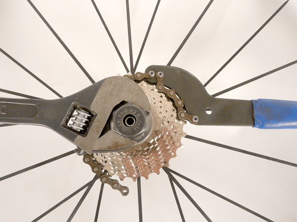 Attempt to unscrew the locknut by pushing down on both handles (attempting to get them to a “half-past-six” position). It may be a bit difficult to crack, especially if it is the first time you have unscrewed it. After the initial force, you should just be able to unscrew it with your fingers.