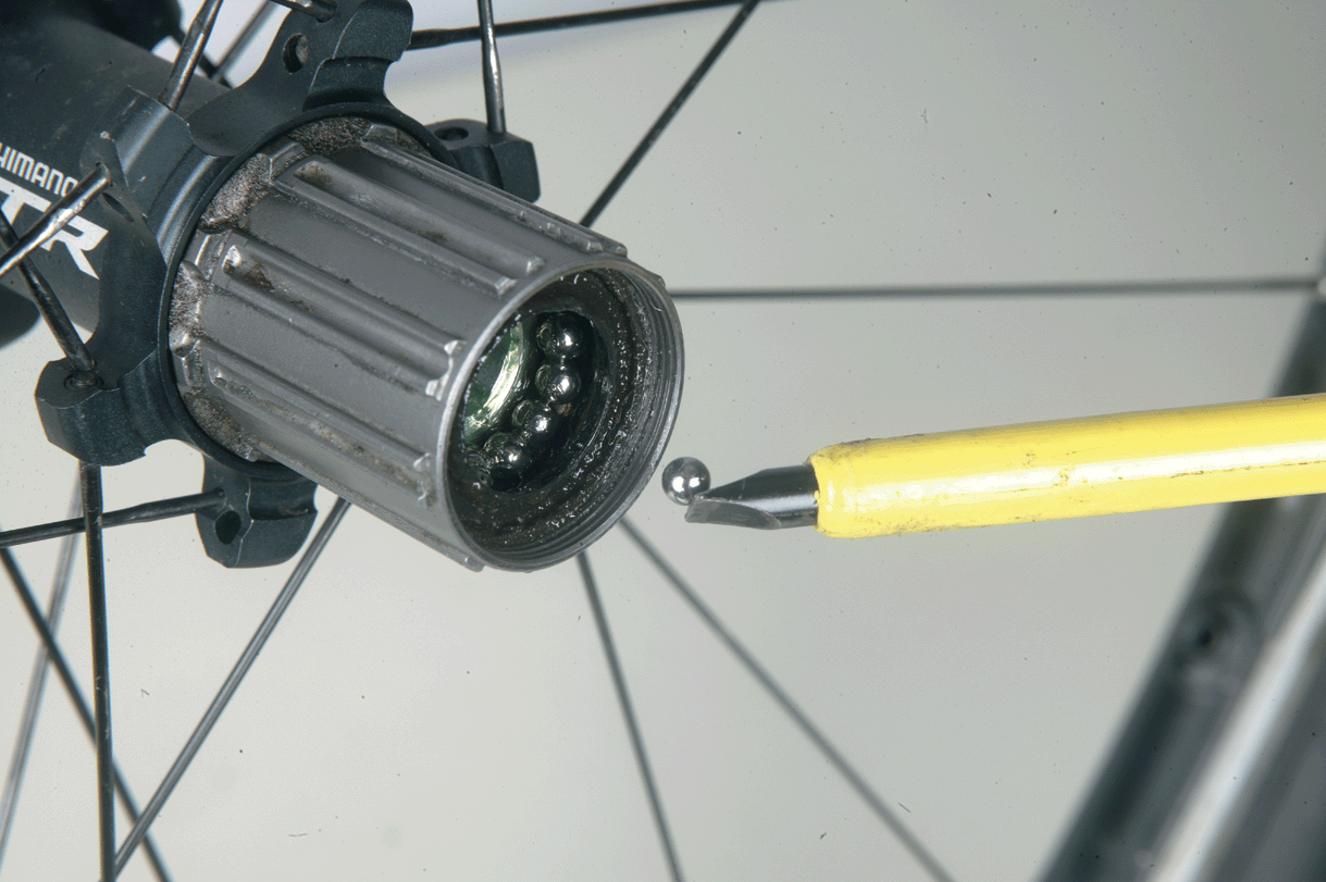 Traditionally bike wheels would use cup and cone bearings. These would have been steel balls riding around inside steel cups of the hub and also on steel cones on the axle. The balls roll around with minimal friction.