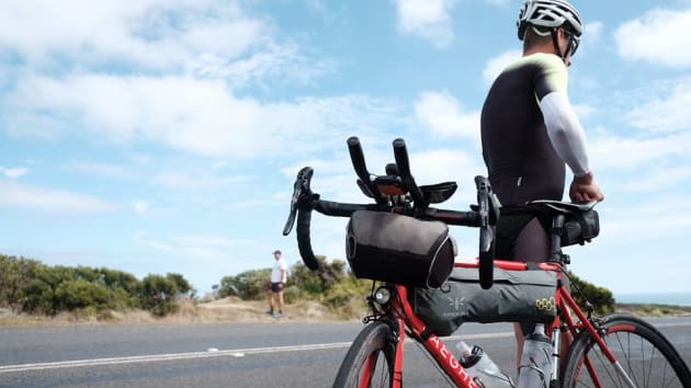 Kristof Allagaert takes a rare few minutes off the bike to enjoy the scenery along the Great Ocean Road. Image: IPWR.