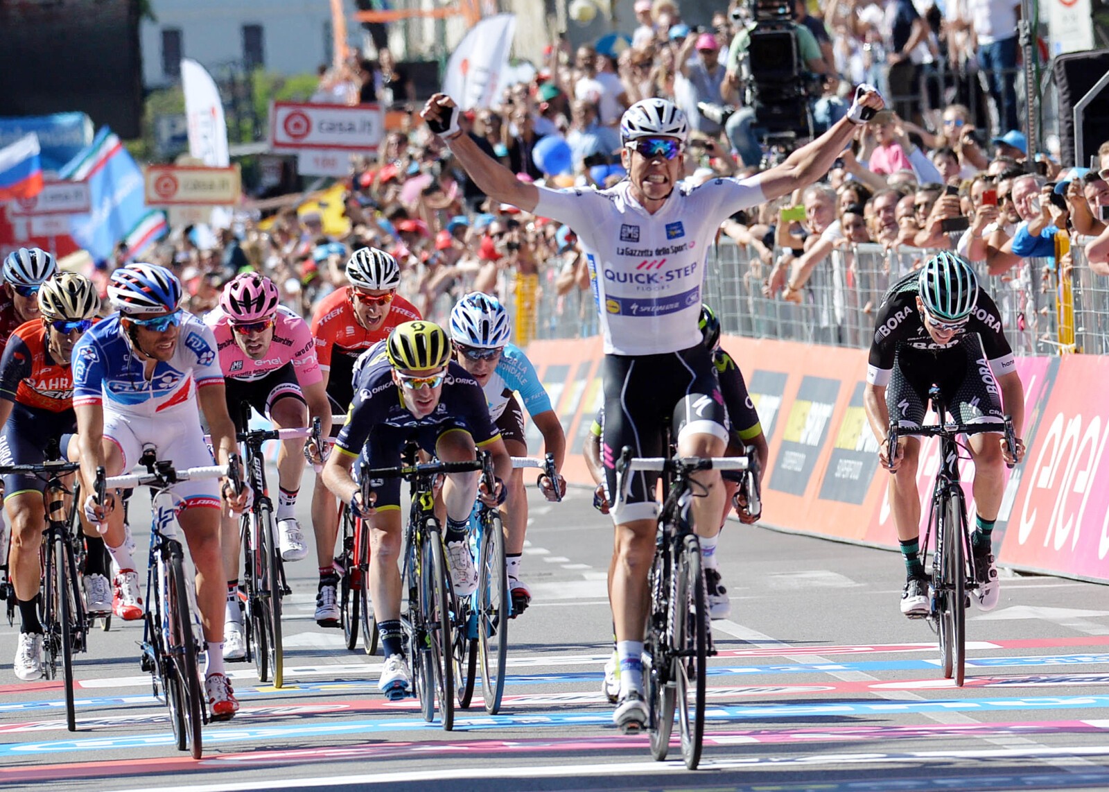 A victorious Bob Jungles after his Stage 15 win. Orica-Scott's Adam Yates (left of frame) finished 4th on the stage. Image: Sirotti.
