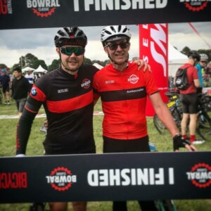 Megan Scott (white jersey) celebrates her Bowral Classic success with members of the Giant Sydney Cycling Club at the event village.