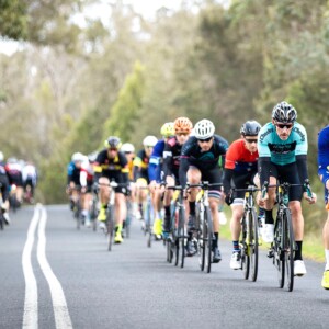 Megan Scott (white jersey) celebrates her Bowral Classic success with members of the Giant Sydney Cycling Club at the event village.
