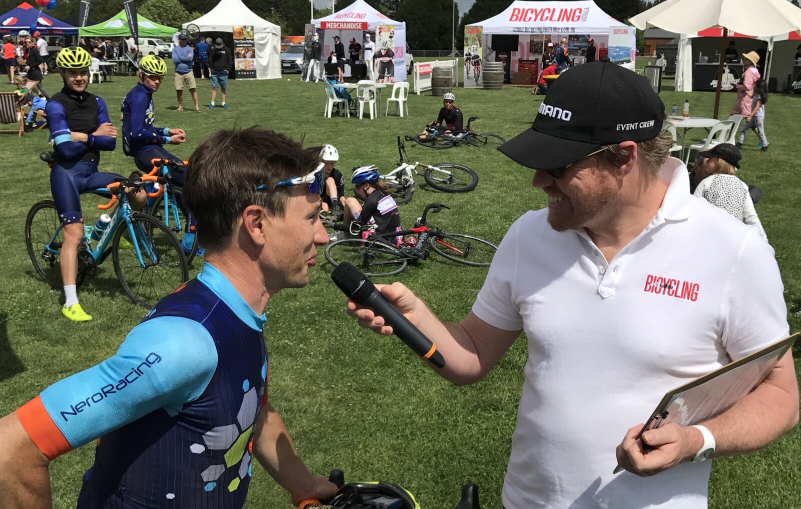 Megan Scott (white jersey) celebrates her Bowral Classic success with members of the Giant Sydney Cycling Club at the event village.