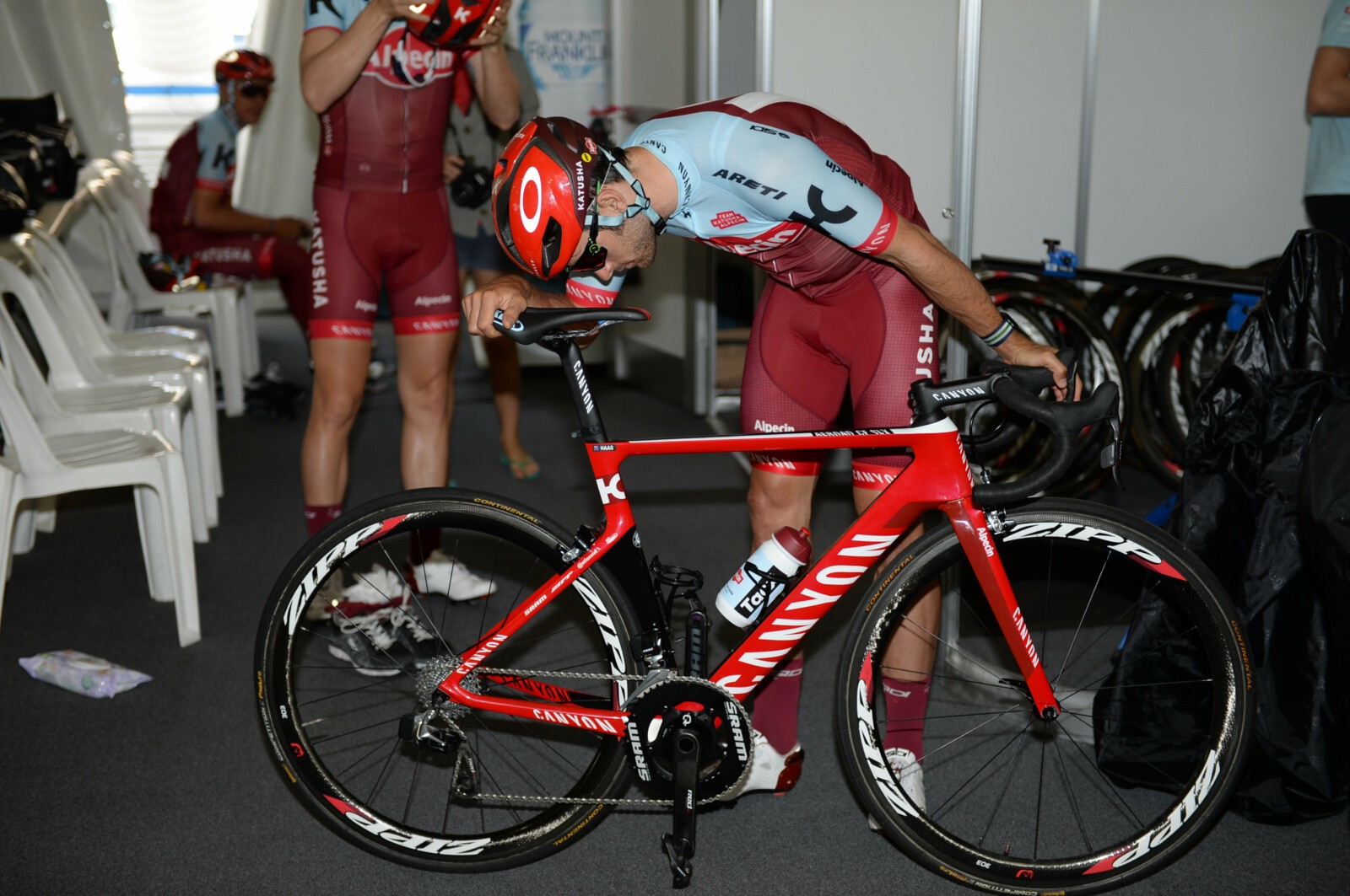 A Katusha mechanic works on one of the team bikes after a 2018 Santos Tour Down Under reeky ride.