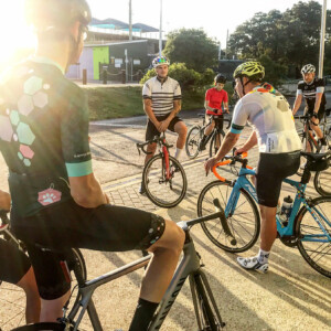 Megan Scott (white jersey) celebrates her Bowral Classic success with members of the Giant Sydney Cycling Club at the event village.