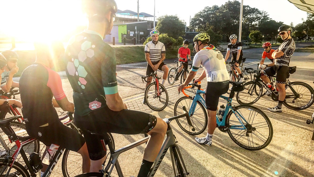 Megan Scott (white jersey) celebrates her Bowral Classic success with members of the Giant Sydney Cycling Club at the event village.