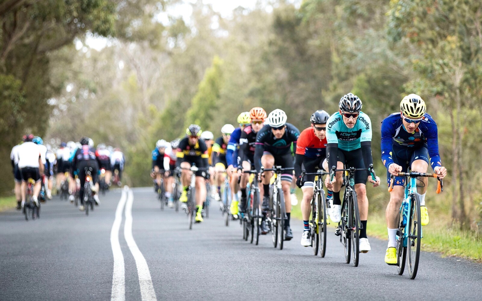 Megan Scott (white jersey) celebrates her Bowral Classic success with members of the Giant Sydney Cycling Club at the event village.