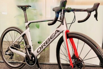 Megan Scott (white jersey) celebrates her Bowral Classic success with members of the Giant Sydney Cycling Club at the event village.