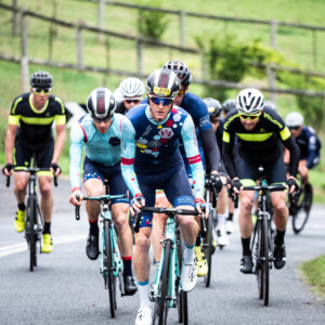 Megan Scott (white jersey) celebrates her Bowral Classic success with members of the Giant Sydney Cycling Club at the event village.